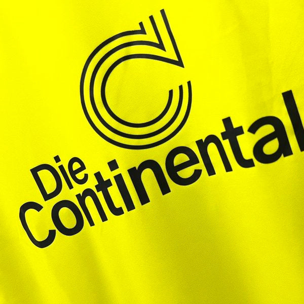 Black 'Die Continentale' logo on a yellow Dortmund 95/96 home shirt
