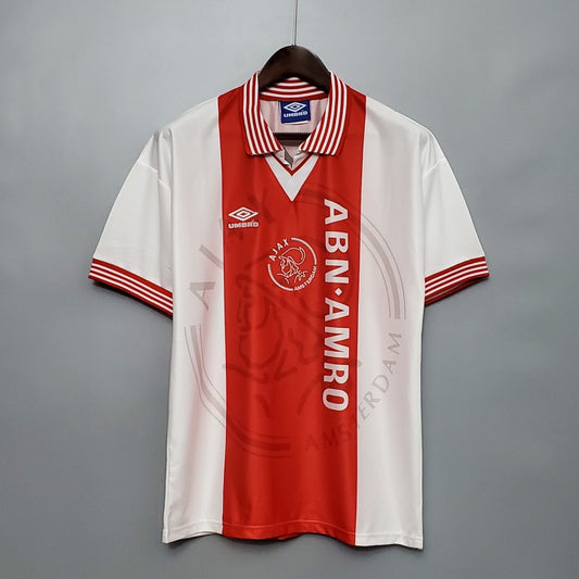 Red and white Ajax 95/96 home shirt with visible branding on a gray background