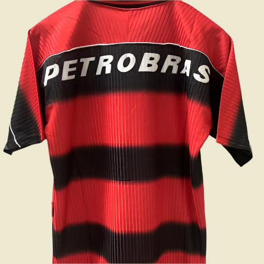 Red and black striped 1997 Flamengo home shirt  with 'Petrobras' logo on a gray background