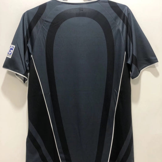 Black 00/01 psg third shirt with white accents on a hanger against a white background
