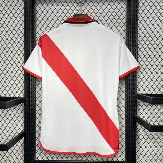 White Rayo vallecano 01/02 home shirt with red diagonal stripe hanging on a rack.