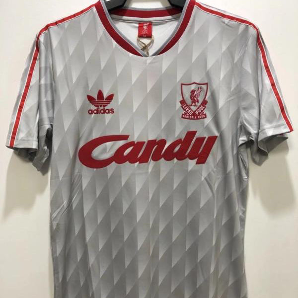 Gray Liverpool 89-91 away shirt with red accents and visible branding on a hanger against a white background