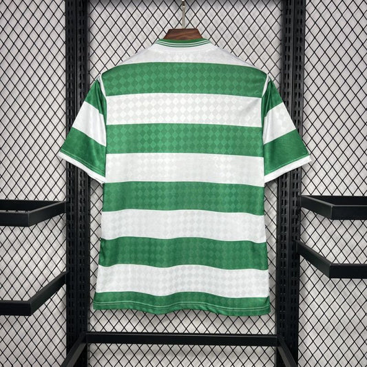 Green and white striped Celtic 87/88 home shirt on a mannequin against a black metal grid background