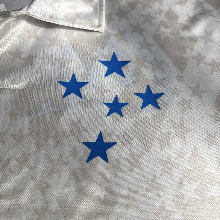 Close-up of a cruzeiro 1993 away shirt with blue star patterns on a textured fabric background