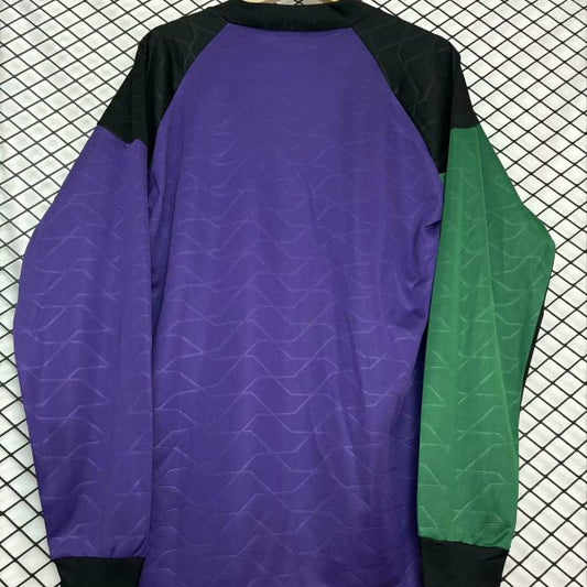 Colorful Newcastle 95/96 gk 2nd shirt with Adidas and Newcastle United logos on a checkered background on a hanger against a grid background