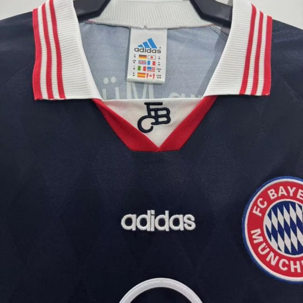 Navy blue Bayern Munich 97/98 home shirt with Adidas and FC Bayern Munich logos on a hanger.