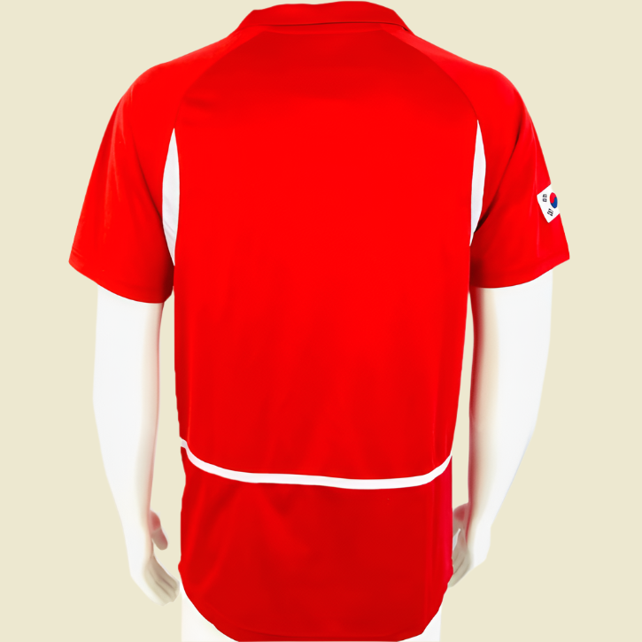 Red South Korea 2002 home shirt with a logo on the sleeve against a white background