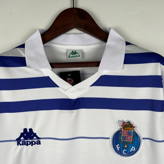 White and blue striped Porto 85/86 away shirt with Kappa logo on a hanger