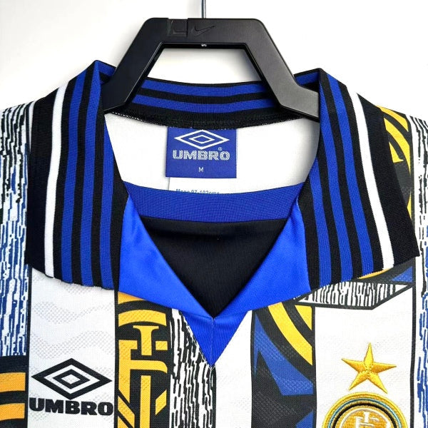 Inter Milan 95/96 away shirt with Umbro logo on a hanger against a white background