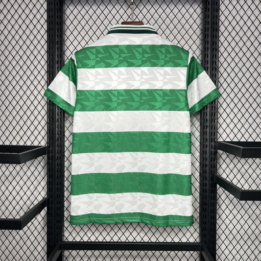 Green and white striped Celtic 89-91 home shirt  on a hanger against a black grid background