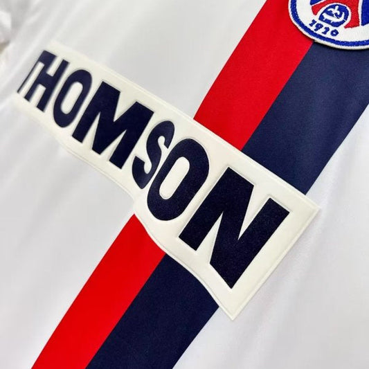 Close-up of a psg 02/03 away shirt with 'THOMSON' branding and Paris Saint-Germain logo.