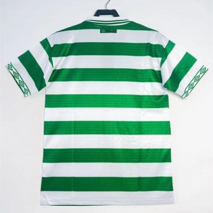 Green and white striped Celtic 98/99 premiership champions home shirt on a hanger against a white background