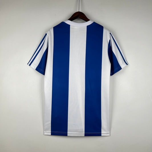 Blue and white striped Porto 90-93 home shirt on a hanger against a plain background