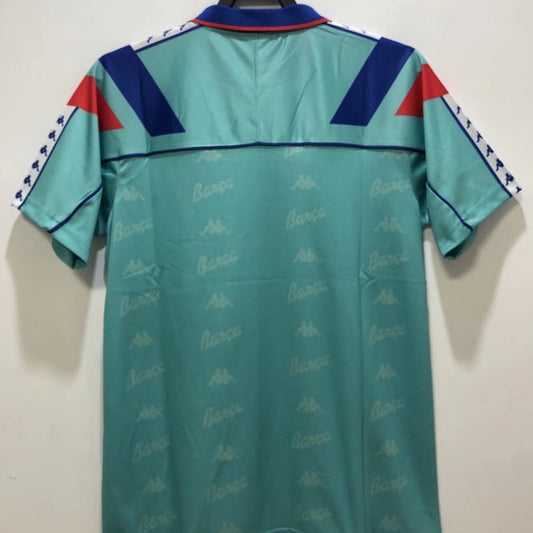Teal Barcelona 92-95 away shirt with red and blue accents on a hanger against a white background