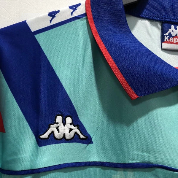 Teal Barcelona 92-95 away shirt with blue collar and Kappa logo on a white background