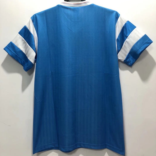 Blue Marseille 90/91 away shirt with white stripes on sleeves against a plain background
