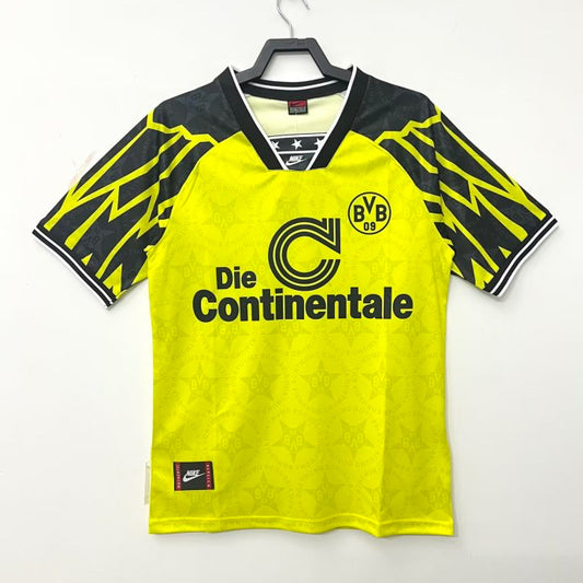 Yellow and black Dortmund 94/95 home shirt with visible branding on a white background