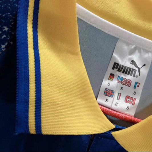 Close-up of a Parma 95/96 third Shirt with a Puma label on a gray background