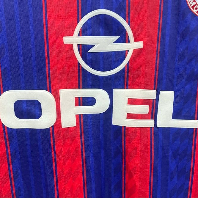 Opel logo on a red and blue striped Bayern Munich 95-97 home shirt