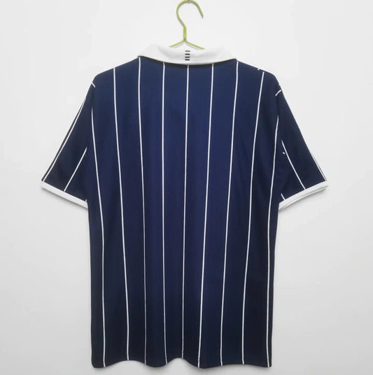 Navy blue Scotland 2002 home shirt with white stripes on a hanger against a white background