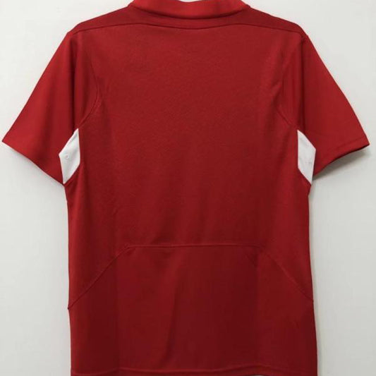 Red Liverpool 2005 champions league final shirt  on a hanger against a white background