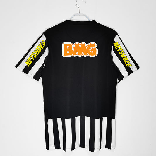 Santos 2012 away shirt orange 'BMG' logo and yellow 'NETSHOES' text on a white background