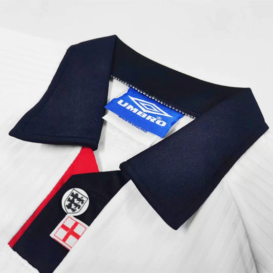 Close-up of a England 1998 home kids kit with visible branding on a white background