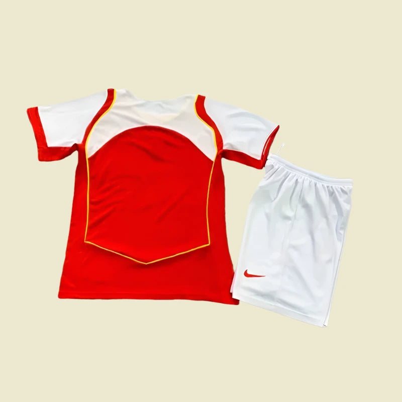 Red arsenal 04/05 home kids kit with white shorts on a white background
