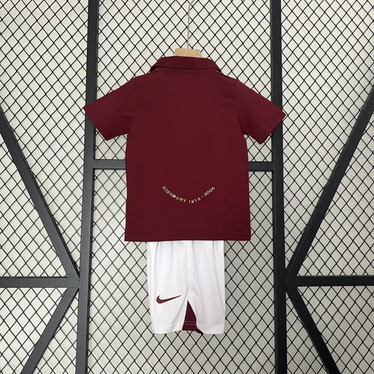 Maroon Arsenal 05/06 commemorative Highbury home kids kit with Nike logo on a grid background