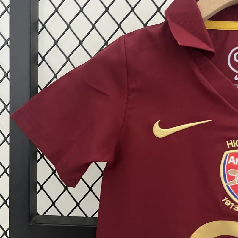 Maroon Arsenal 05/06 commemorative Highbury home kids kit with Nike logo and Arsenal FC emblem on a hanger.