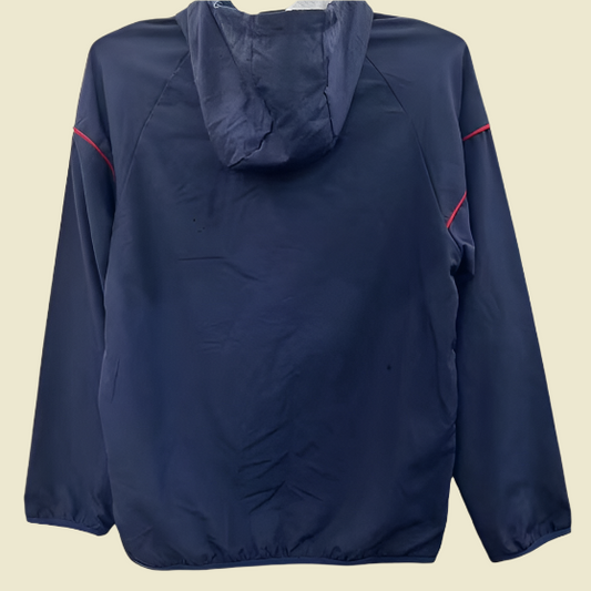 Navy blue arsenal 01/02 windbreaker jacket with red accents on a gray background