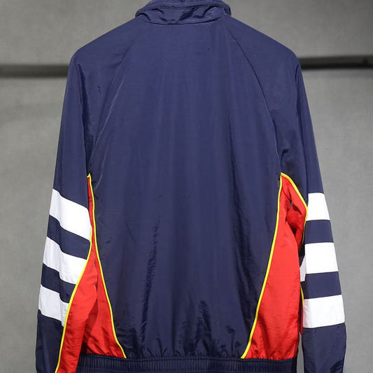 Navy Arsenal 91-93 windbreaker jacket with red and white stripe accents on a gray background