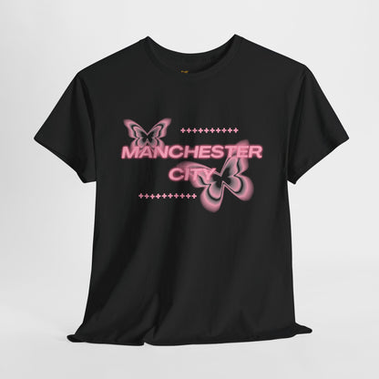 Black t-shirt with pink butterfly graphics and 'Manchester City' text on a light gray background