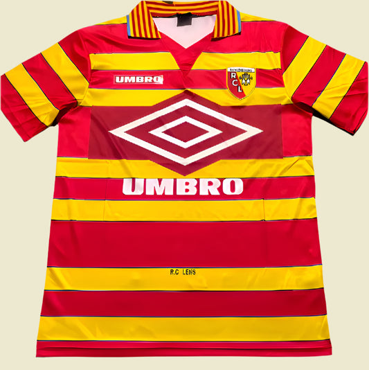 Red and yellow striped lens 97/98 home shirt with Umbro logo on a gray surface
