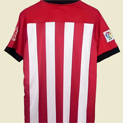 Red and white striped athletic Bilbao 11/12 home shirt with a logo on a gray background