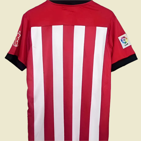 Red and white striped athletic Bilbao 11/12 home shirt with a logo on a gray background