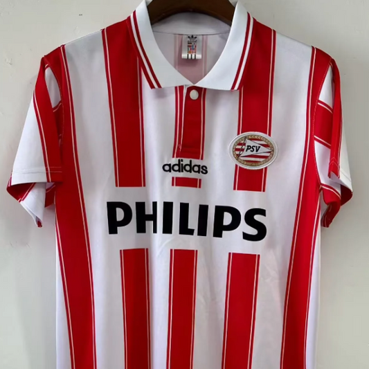 Red and white striped Psv 94/95 home shirt with Adidas and Philips logos on a hanger.