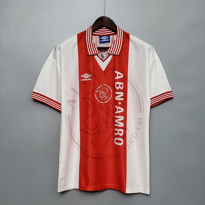 Red and white Ajax 95/96 home shirt with visible branding on a gray background