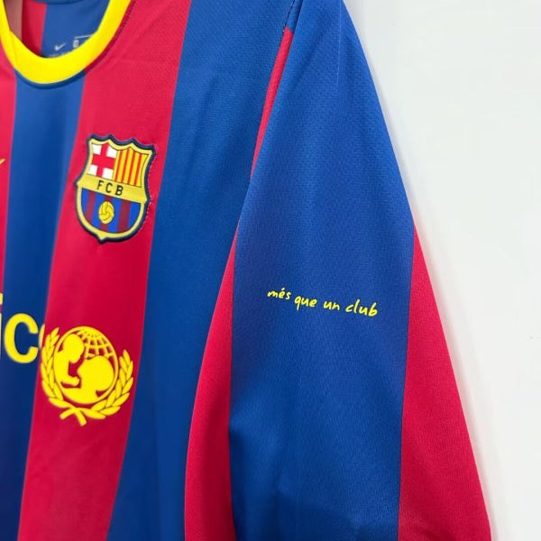 Barcelona 10/11 home football club jersey with logo on a hanger