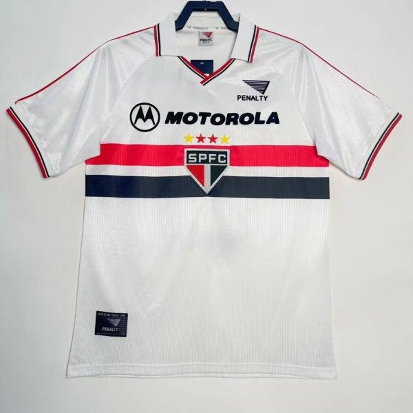 White 2000 São Paulo home shirt with branding on a hanger against a white background