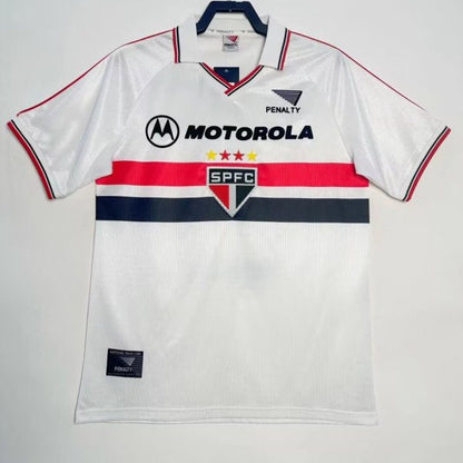 White 2000 São Paulo home shirt with branding on a hanger against a white background