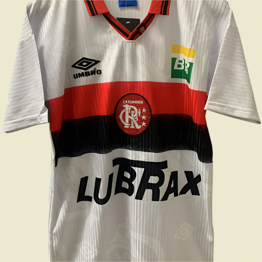 White 1997 Flamengo away shirt with red and black accents, featuring various brand logos, on a hanger against a gray background.
