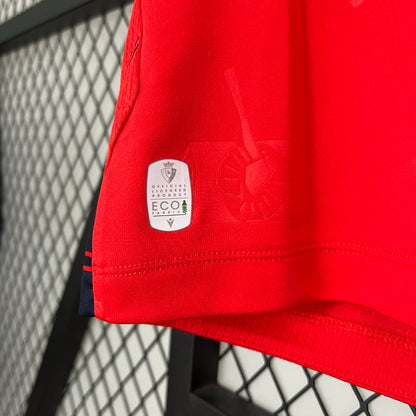 Red Osasuna 96/97 home shirt with a visible brand logo and 'Eco' label against a metal fence background