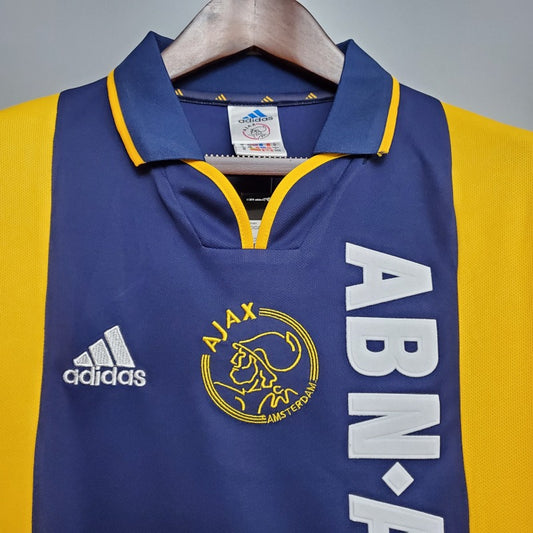 Blue and yellow Ajax 00/01 away shirt with Adidas and Ajax logos on a hanger.