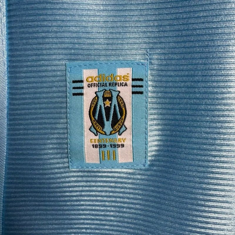 Close-up of an Adidas label on a blue Marseille 98/99 away shirt 