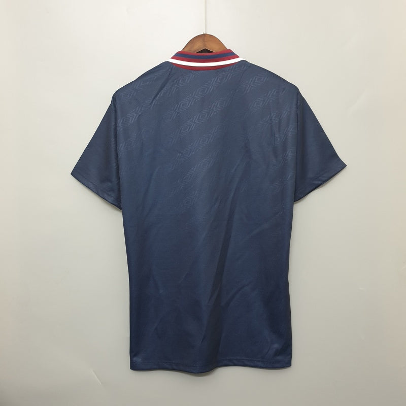 Navy blue Ajax 94/95 away shirt on a hanger against a white background