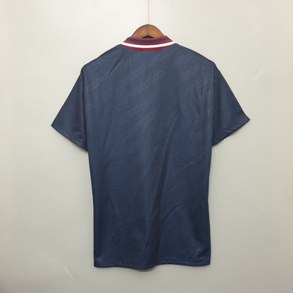 Navy blue Ajax 94/95 away shirt on a hanger against a white background