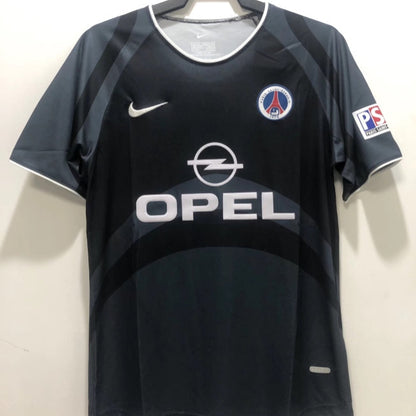 Black 00/01 psg third shirt with Opel logo on a hanger against a white background