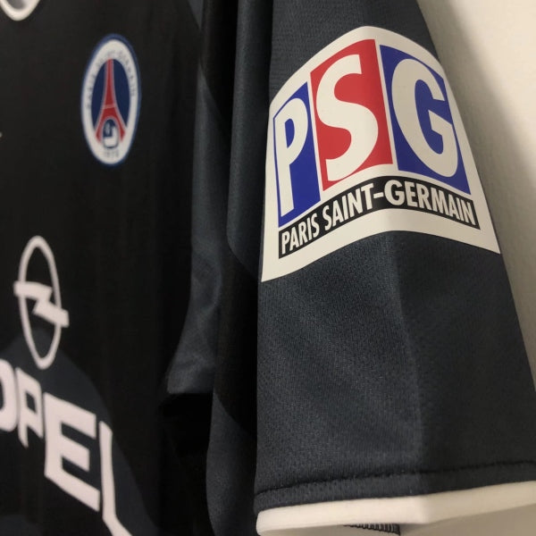 Black 00/01 psg third shirt with PSG and Opel logos on a plain background