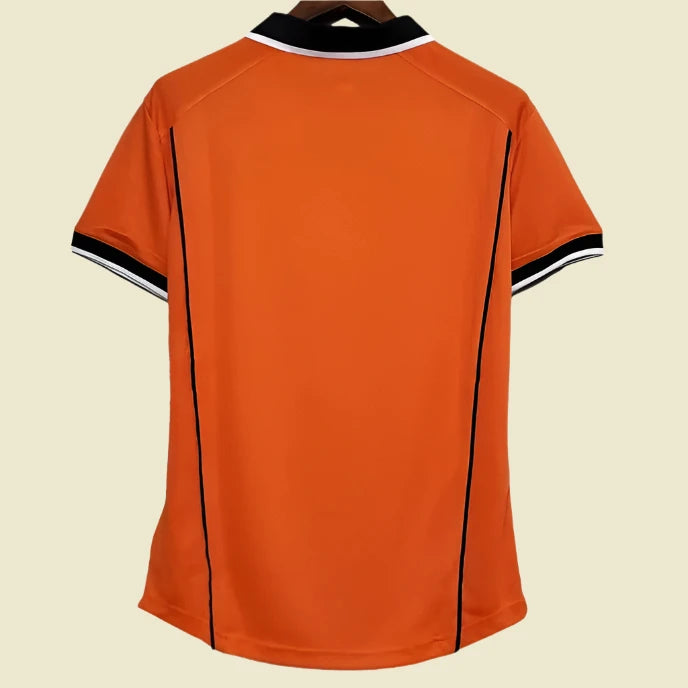 Orange Netherlands 98 World Cup home shirt with black accents on a hanger against a white background